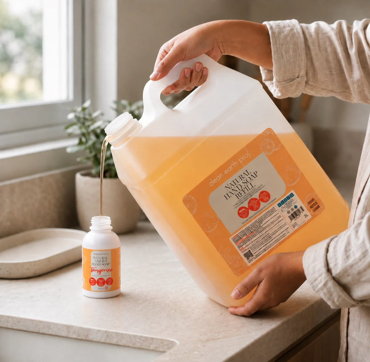 Refilling a reusable dispenser bottle with Clean Earth natural foaming liquid hand soap from a 10L bulk jug