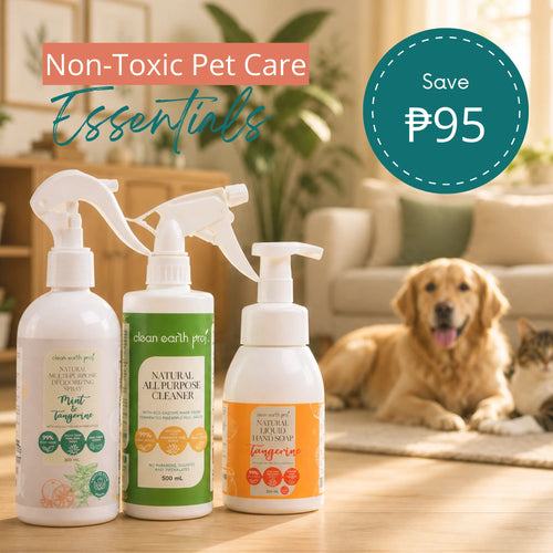 Three Clean Earth eco-friendly cleaning products—Mint & Tangerine Deodorizing Spray, Holy Basil All-Purpose Cleaner, and Tangerine Liquid Hand Soap—displayed on a table with a dog resting in the background and text reading "Non-Toxic Pet Care Essentials"